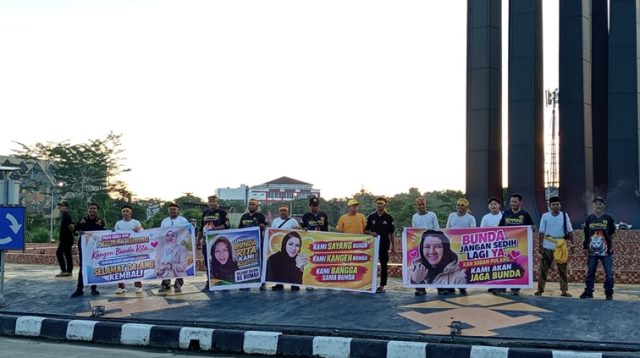 Warga Tenggarong yang membentangkan spanduk menyambut kepulangan mantan Bupati Kukar, Rita Widyasari. (Lingkar Kaltim/M. As'ari)