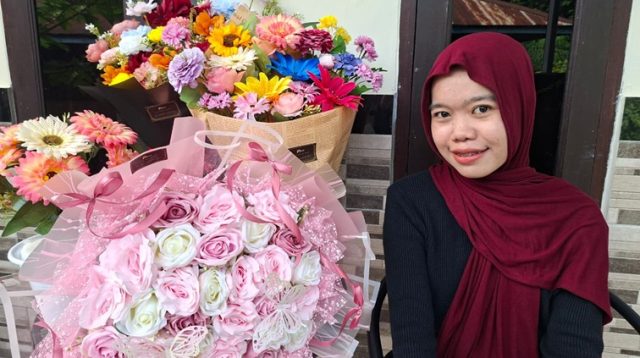 Anis beserta bucket bunga yang dijualnya, Selasa (23/6/26). (Dilla/lingkarkaltim)