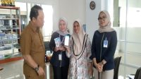 Plt. Kepala Disperindag Kukar, Sayid Fathullah bersama pedagang saat menunjukkan sistem pembayaran retribusi lapak secara non-tunai (Kiki/Lingkarkaltim)