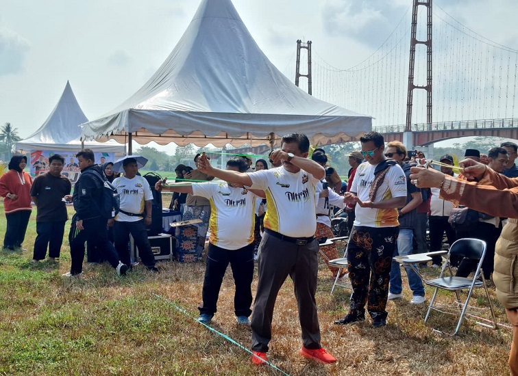 Sekda Kukar Sunggono beserta Kepala Dispora Kukar Aji Ali Husni mencoba permain ketapel di halaman parkrir pulau kumala,Senin (21/9/26). (Dilla/lingkarkaltim)